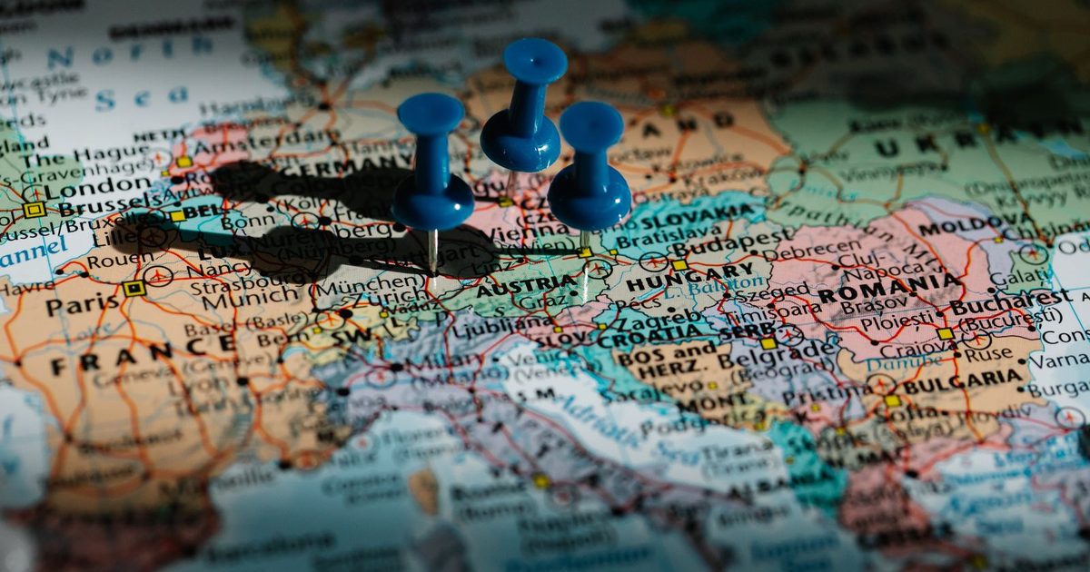 Blue pushpins on a map of Europe