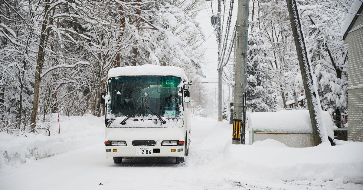 A bus on a road in heavy snow, Hakuba, Japan