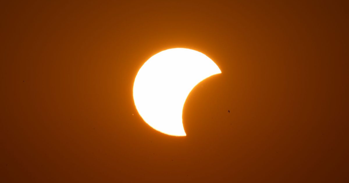 A partial solar eclipse at sunset in Garešnica, Croatia