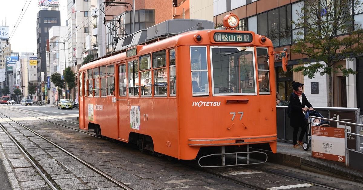 An orange streetcar in Matsuyama, Japan