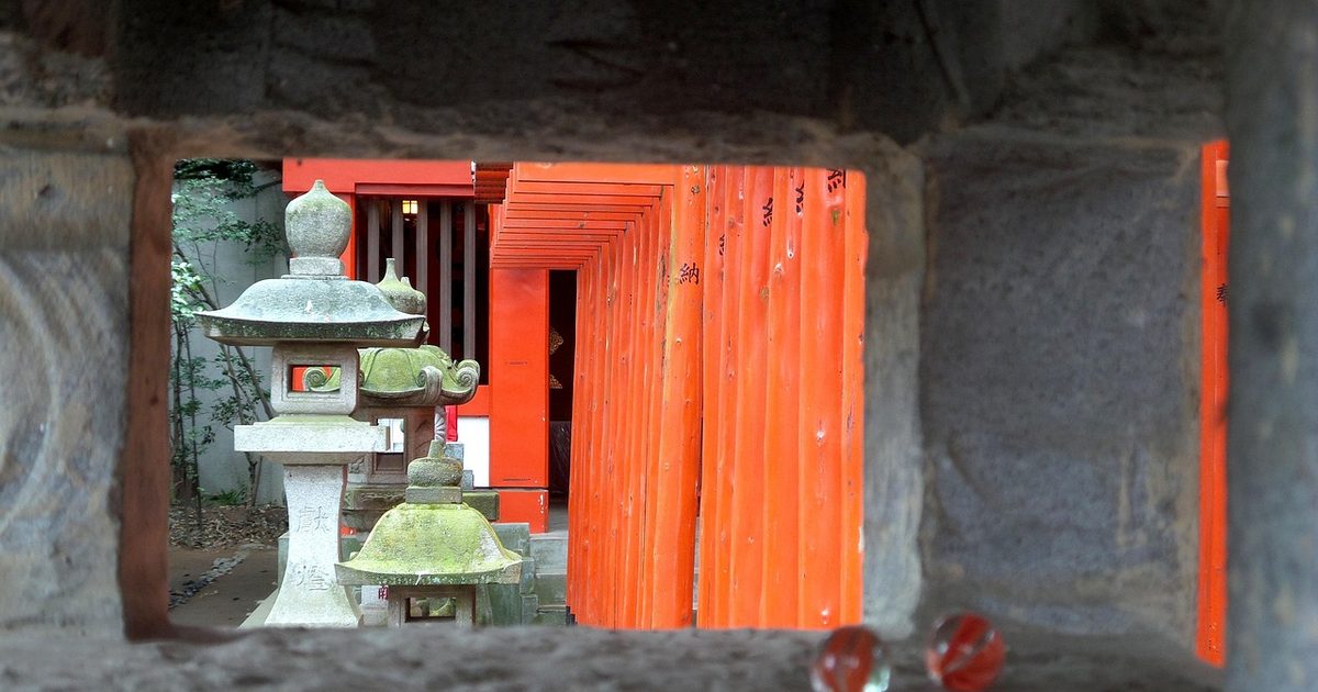 A stone lantern and torii gates at a temple in Utsunomiya, Japan